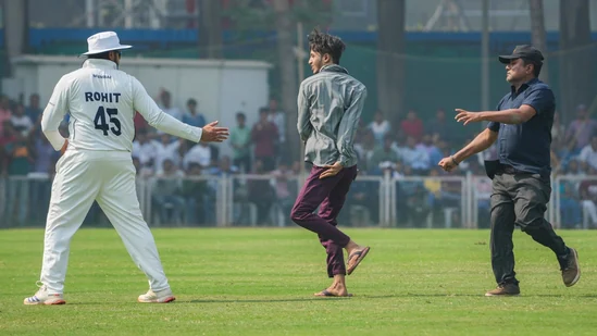 Rohit Sharma embraces pitch invader as fan breaches security to meet India captain during Ranji Trophy match